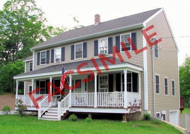 view of front of home with covered porch, a chimney, and a front lawn