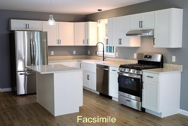 kitchen with appliances with stainless steel finishes, white cabinets, under cabinet range hood, and wood finished floors