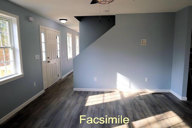 foyer entrance featuring baseboards and wood finished floors