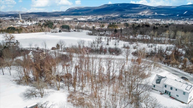 snowy aerial view with a mountain view