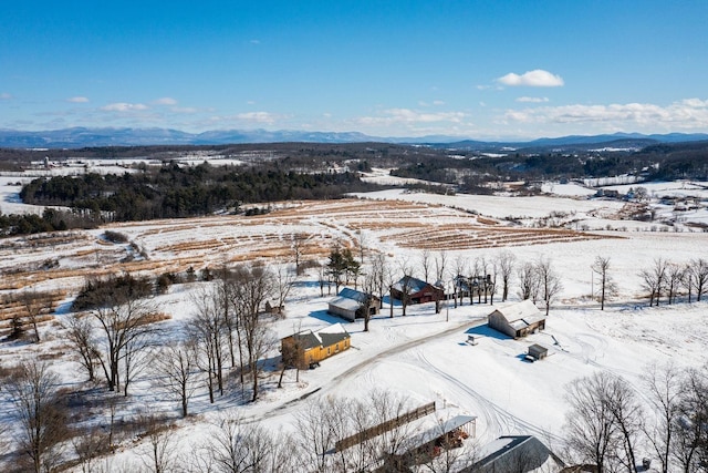 snowy aerial view featuring a mountain view