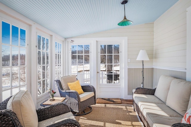 sunroom / solarium with lofted ceiling and a healthy amount of sunlight