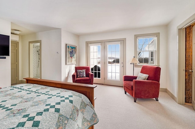 bedroom with access to outside, light colored carpet, baseboards, and multiple windows