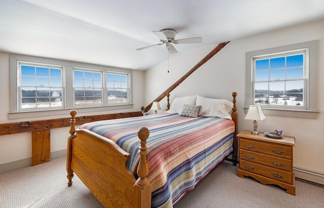 carpeted bedroom with a baseboard heating unit and a ceiling fan