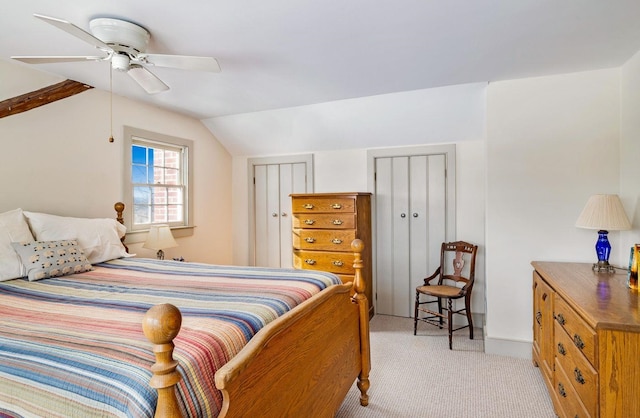 bedroom with lofted ceiling, ceiling fan, and light carpet