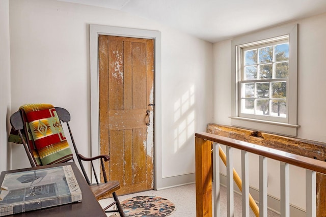 interior space with carpet and baseboards