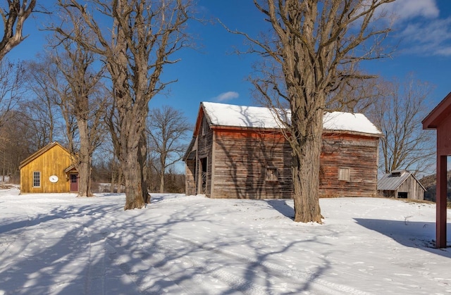 yard layered in snow with an outdoor structure