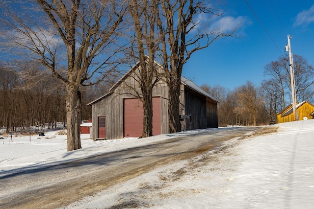 snow covered structure featuring an outdoor structure