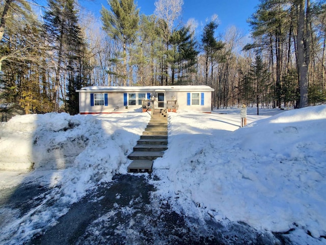 view of front of home featuring a wooded view