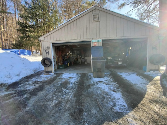 snow covered garage with a garage