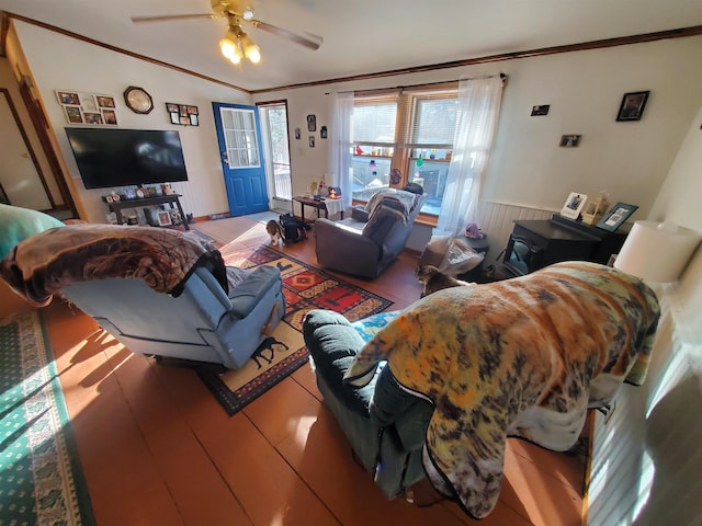 living room featuring a wainscoted wall, a ceiling fan, and crown molding