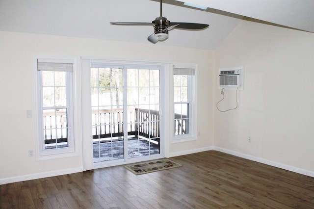 interior space with lofted ceiling, a wall mounted air conditioner, baseboards, and wood finished floors