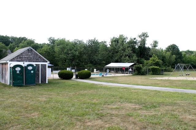 view of yard featuring an outdoor structure and fence