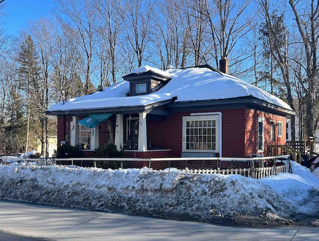 view of front of property featuring covered porch and a chimney