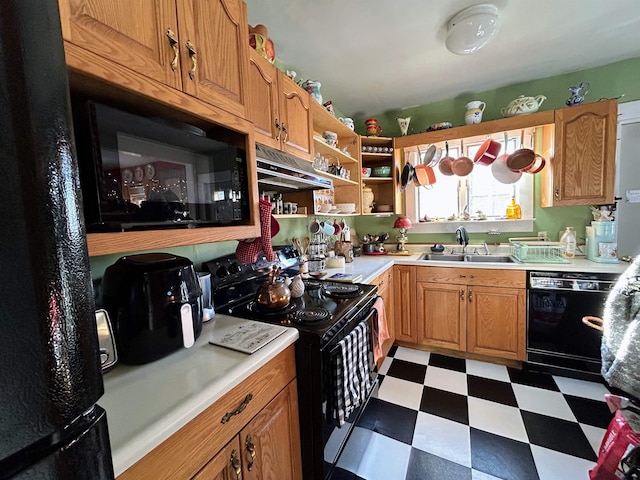 kitchen with light countertops, a sink, under cabinet range hood, black appliances, and tile patterned floors