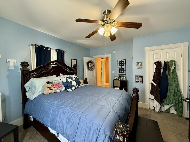 carpeted bedroom featuring radiator heating unit, ceiling fan, and baseboards