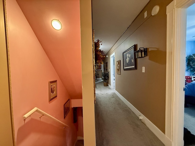 corridor featuring carpet floors and baseboards