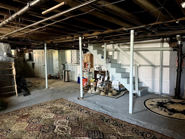 unfinished basement featuring stairway