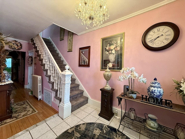 stairs featuring visible vents, radiator heating unit, tile patterned floors, an inviting chandelier, and crown molding