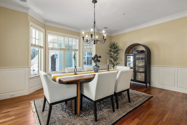 dining area featuring dark wood-type flooring, a wealth of natural light, and a chandelier