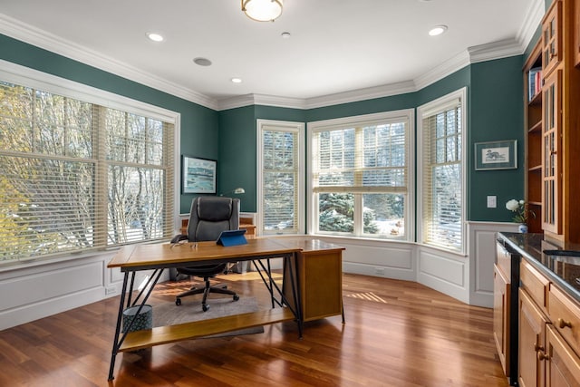 home office with a wainscoted wall, ornamental molding, a decorative wall, and wood finished floors