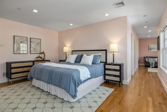 bedroom featuring baseboards, recessed lighting, visible vents, and light wood-style floors