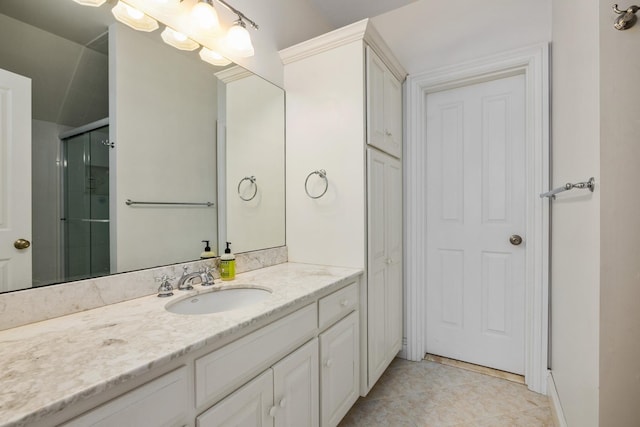 bathroom with a stall shower, tile patterned flooring, and vanity