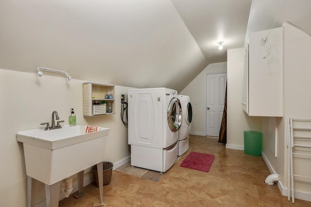 laundry room with baseboards, cabinet space, a sink, and washing machine and clothes dryer