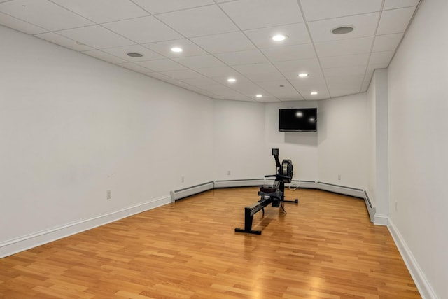 exercise area with light wood-type flooring, baseboards, and recessed lighting