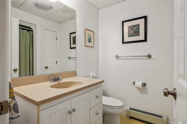 bathroom featuring a baseboard heating unit, visible vents, vanity, and toilet