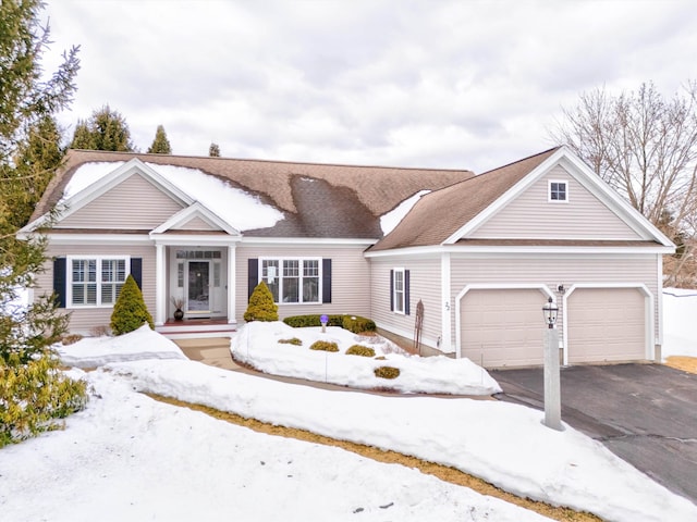 view of front of home featuring an attached garage and aphalt driveway