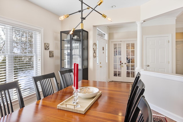 dining room with french doors and ornate columns