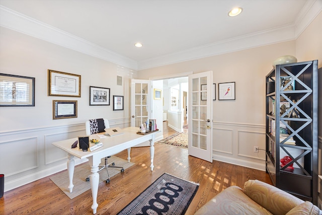 home office featuring french doors, crown molding, recessed lighting, a decorative wall, and wood finished floors