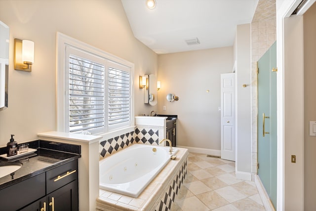 bathroom with visible vents, lofted ceiling, a jetted tub, a shower stall, and two vanities