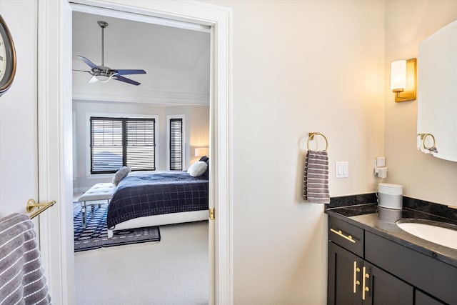 ensuite bathroom featuring ensuite bathroom, vanity, and a ceiling fan