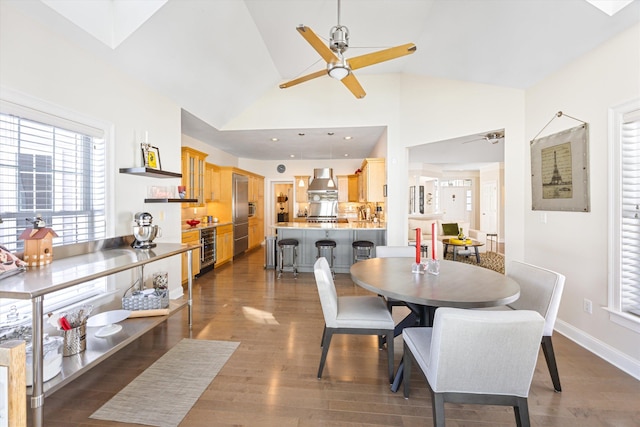 dining room featuring dark wood-style floors, beverage cooler, ceiling fan, and baseboards