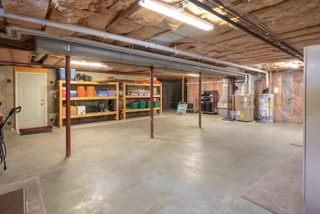 unfinished basement featuring gas water heater and heating unit