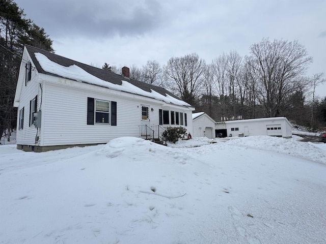 view of front of property with a garage and a chimney