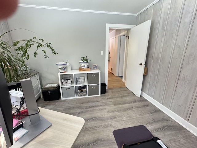 interior space featuring ornamental molding and wood finished floors