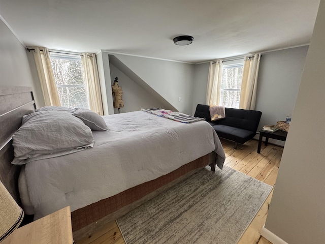 bedroom with wood-type flooring and crown molding