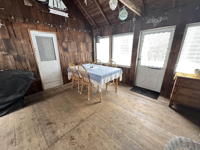 sunroom / solarium featuring lofted ceiling and wood ceiling