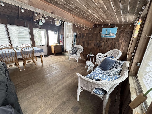 interior space featuring wooden ceiling, wood finished floors, and wooden walls