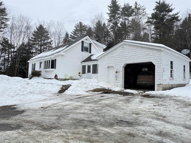 snow covered property featuring a garage