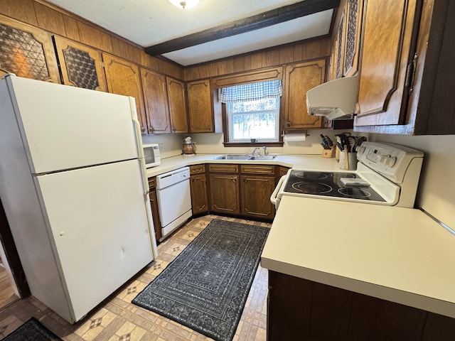 kitchen featuring light floors, light countertops, a sink, ventilation hood, and white appliances