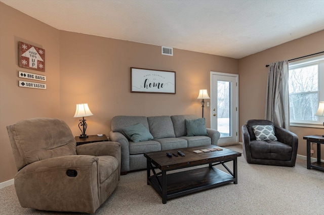 living room featuring carpet floors, baseboards, and visible vents