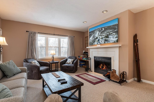 living area with carpet floors, a lit fireplace, and baseboards