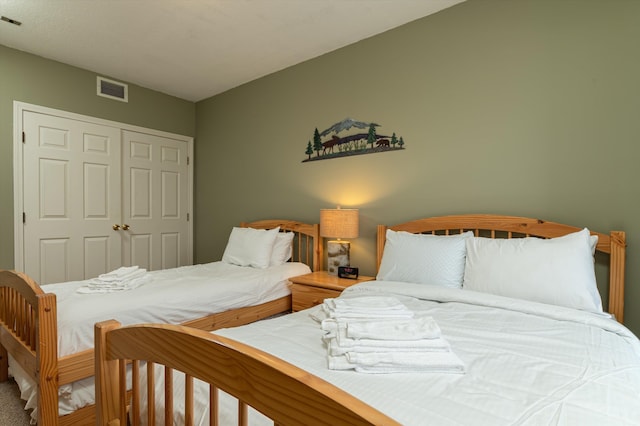 bedroom featuring a closet and visible vents