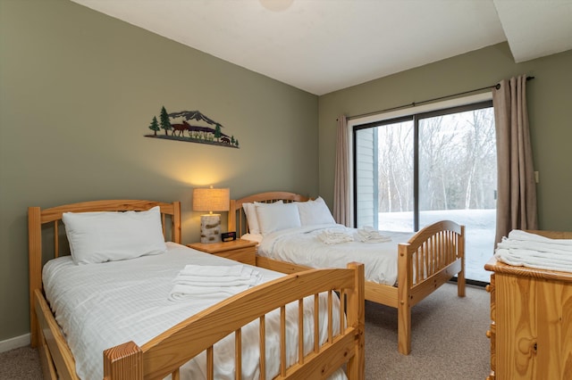 carpeted bedroom with access to outside and baseboards