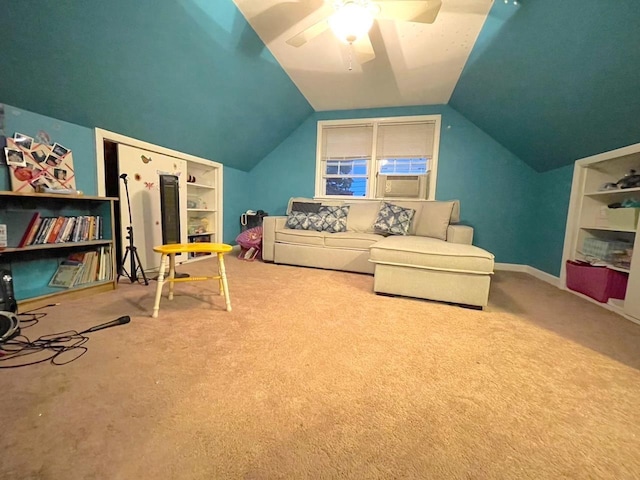 interior space with carpet floors, built in shelves, lofted ceiling, a ceiling fan, and baseboards