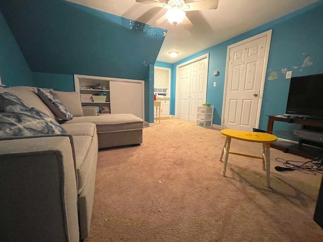 carpeted living room featuring a ceiling fan and baseboards